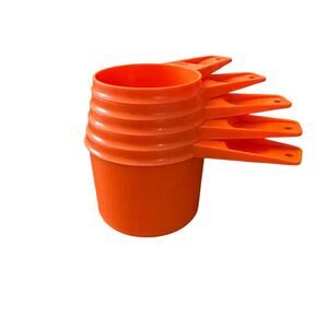 Vintage orange Tupperware measuring cup set.  5 cups missing the 1/4 cup.  EUC